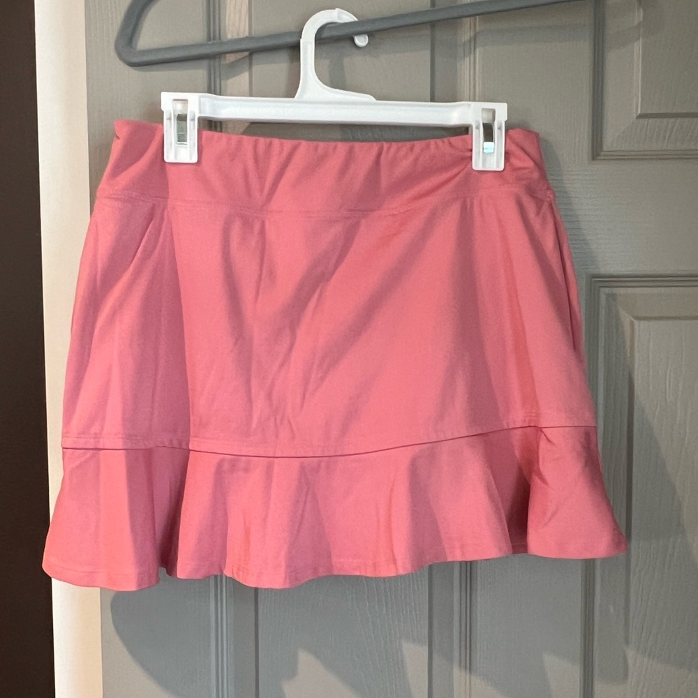 Tommy Bahama golf skort. Built in shorts. Size L. Salmon color. Like new.